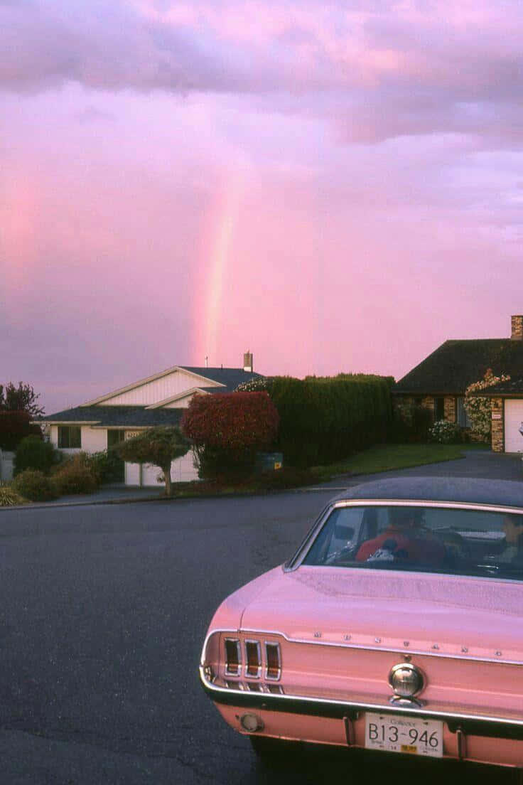 A Pink Car Parked In A Driveway Wallpaper