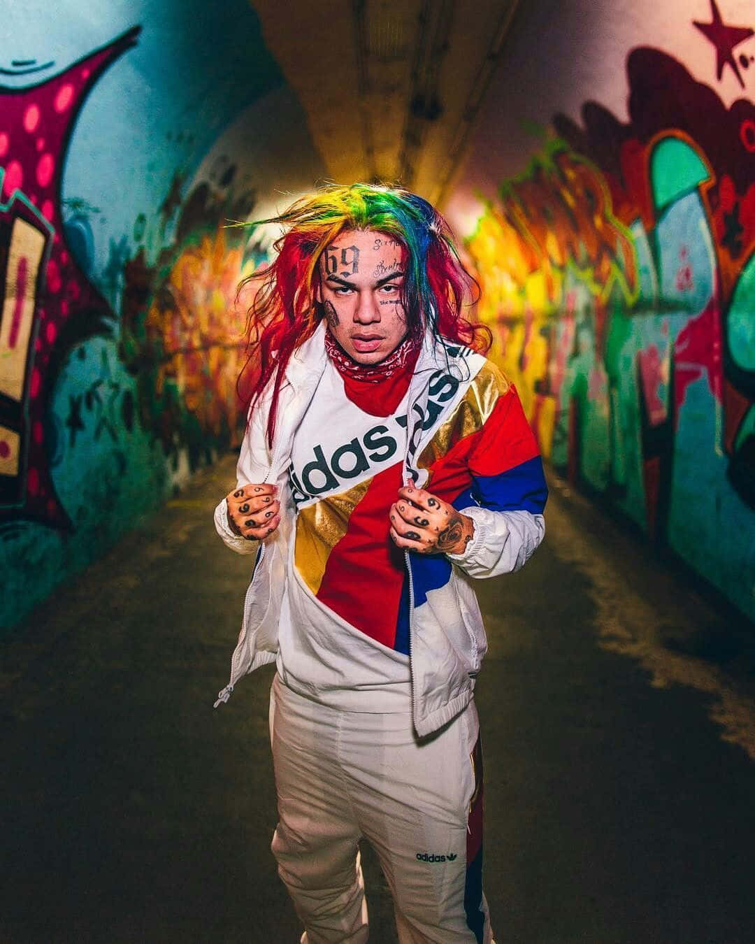 A Person In A Colorful Outfit Standing In A Tunnel Wallpaper