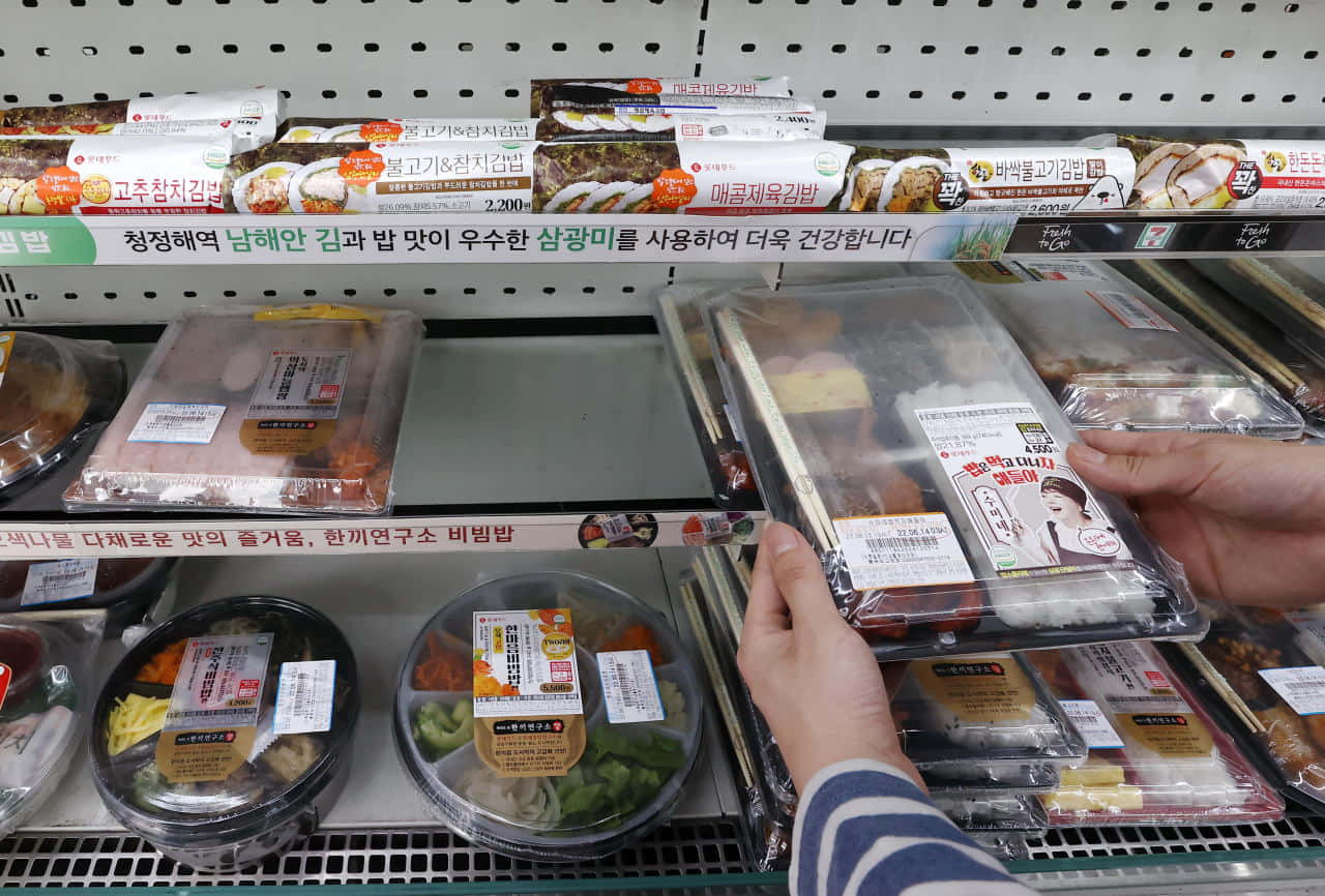 A Person Is Choosing Food From A Shelf