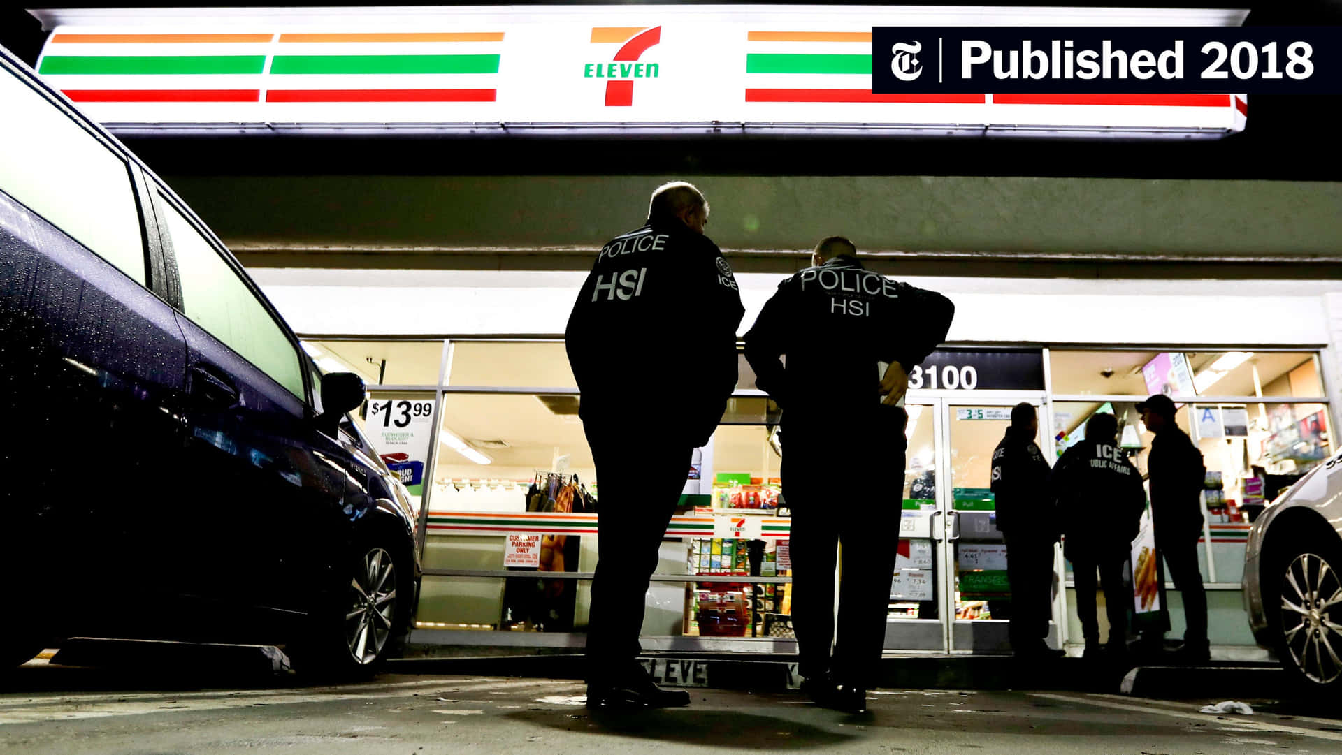 Two Police Officers Standing Outside A 7-eleven Store