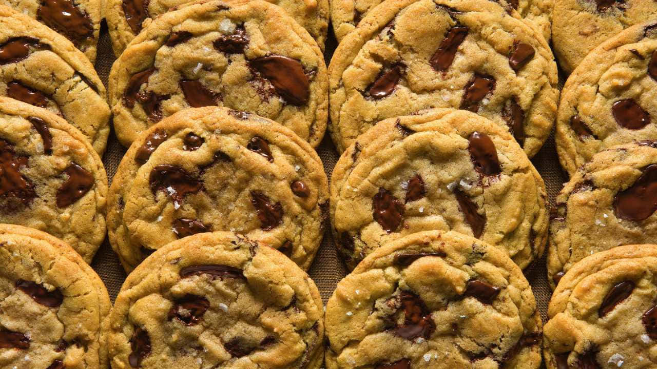 A Large Group Of Chocolate Chip Cookies On A Tray