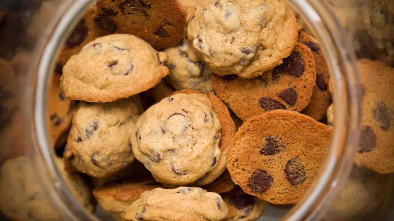 A Jar Of Cookies In A Glass Bowl