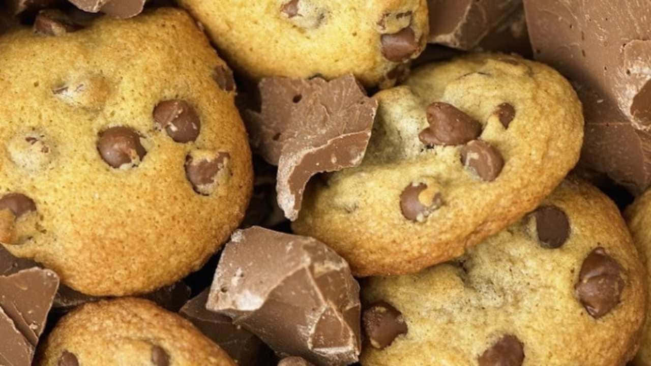 Chocolate Chip Cookies Are Piled Up On Top Of Each Other