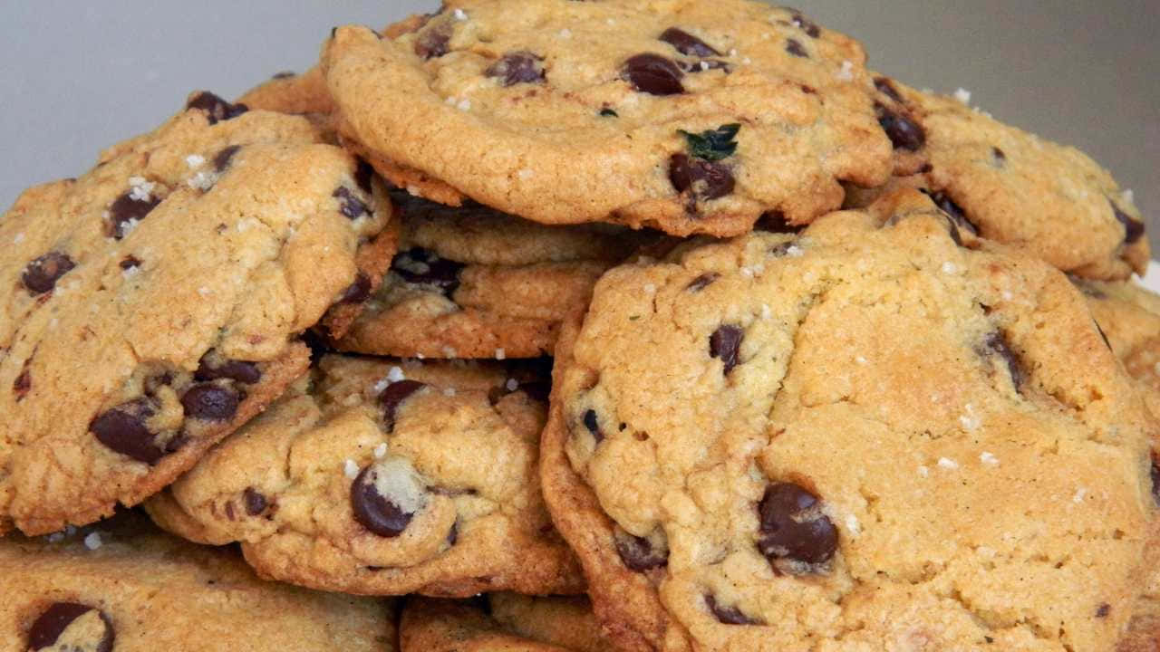 A Pile Of Chocolate Chip Cookies With Sea Salt
