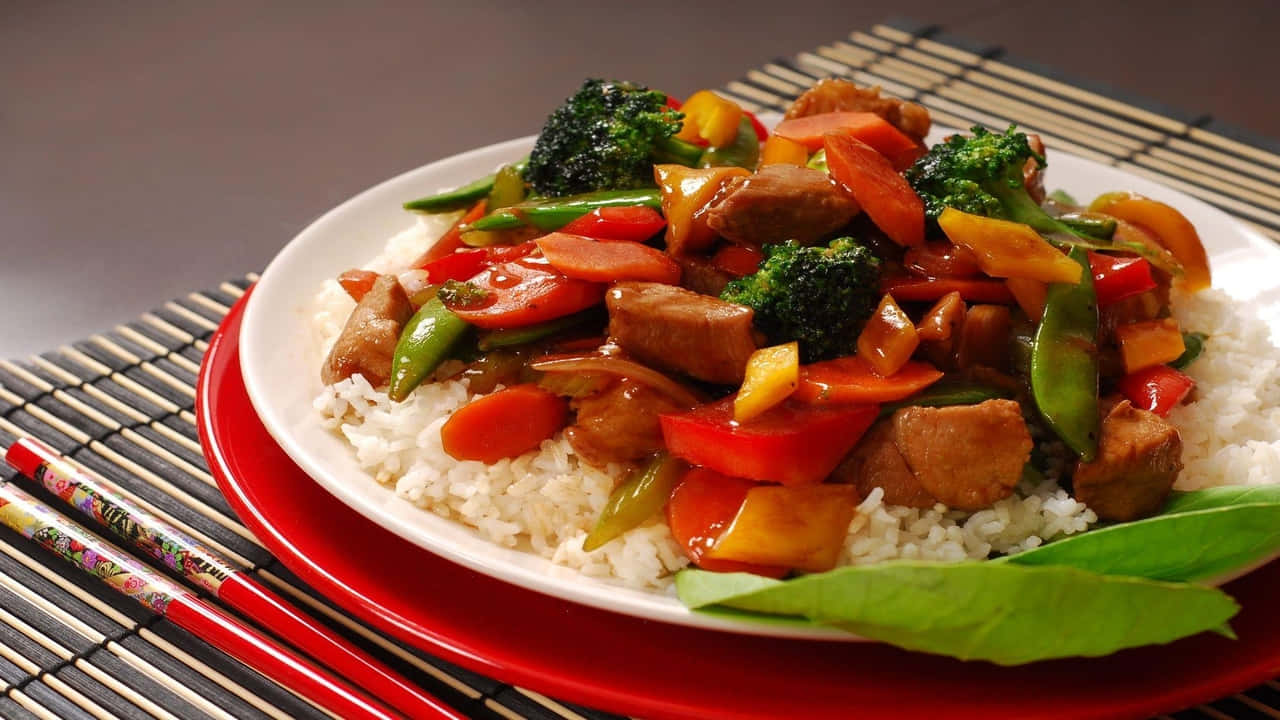 A Plate Of Stir Fried Vegetables And Meat