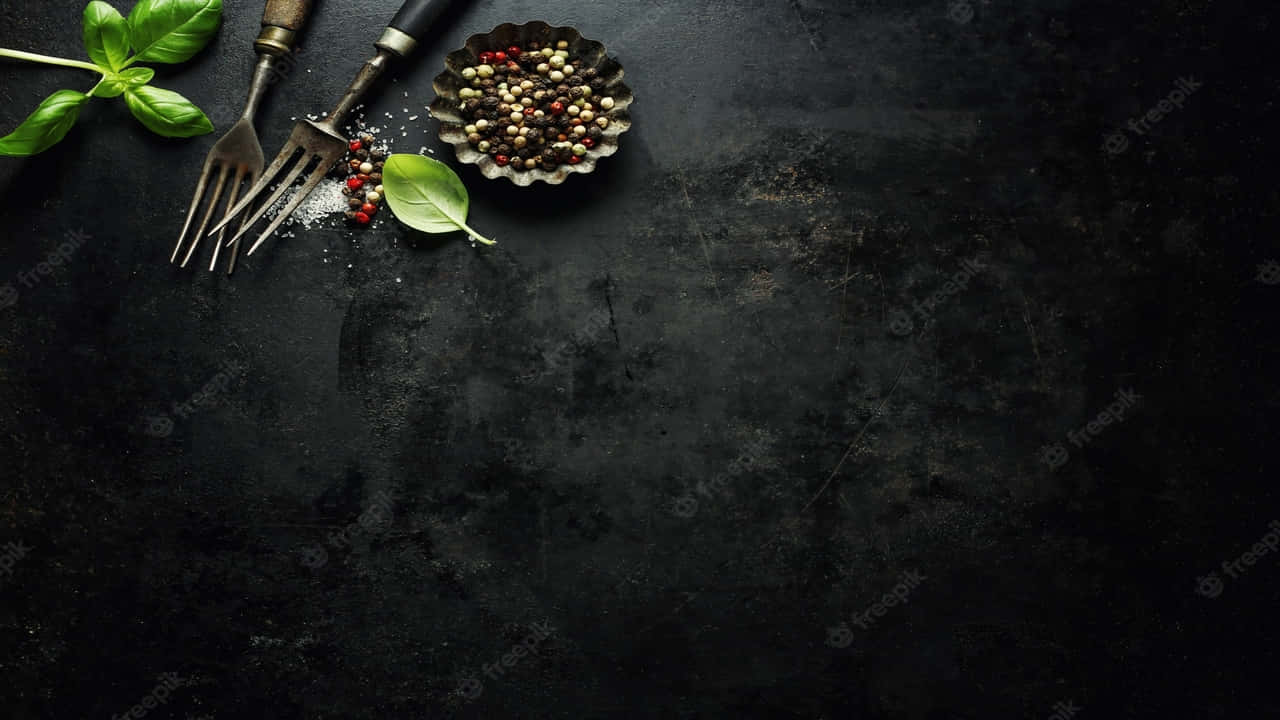 A Black Background With Spices And Herbs On It