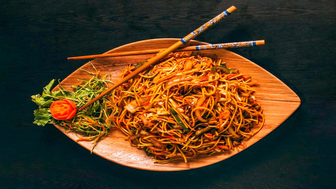 A Plate With Noodles And Chopsticks