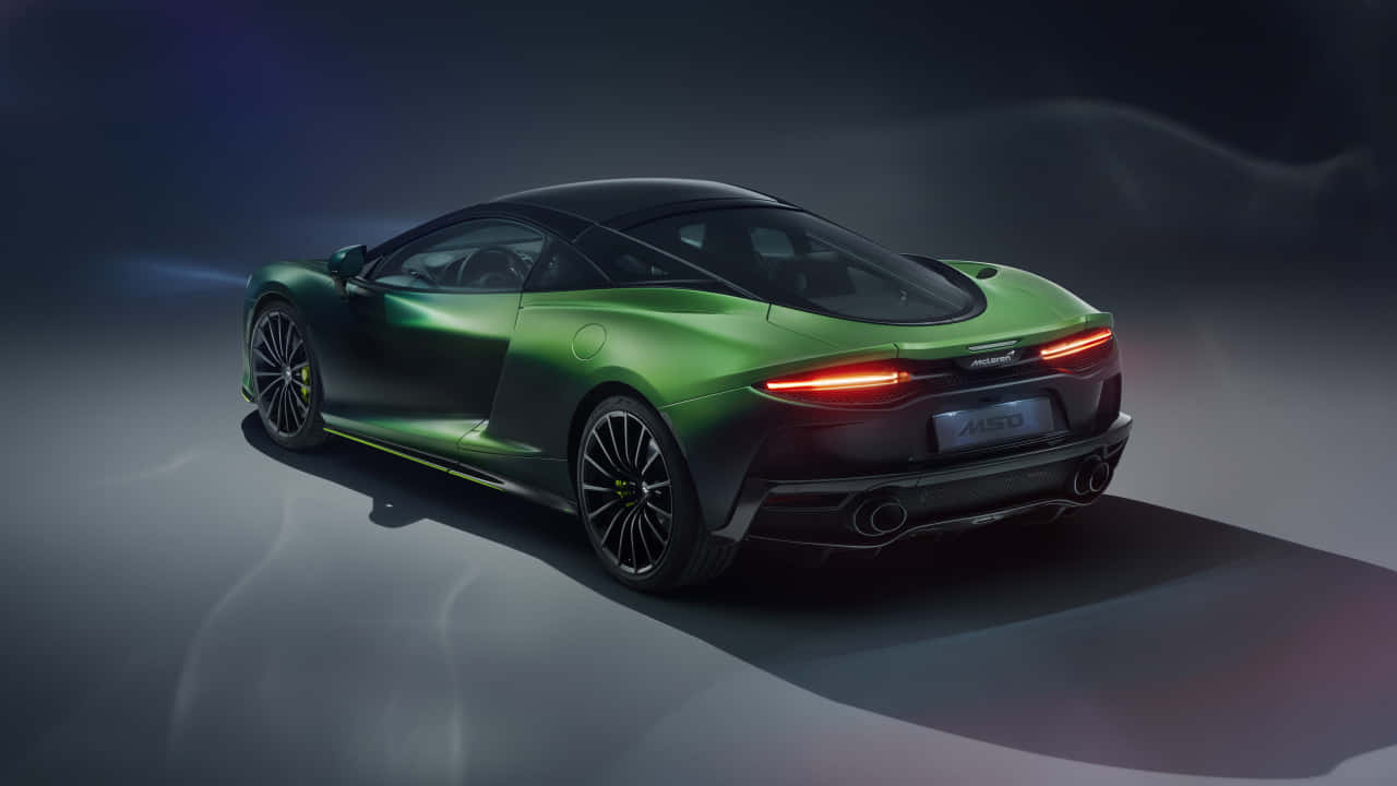 A Green Sports Car Is Shown In A Dark Background