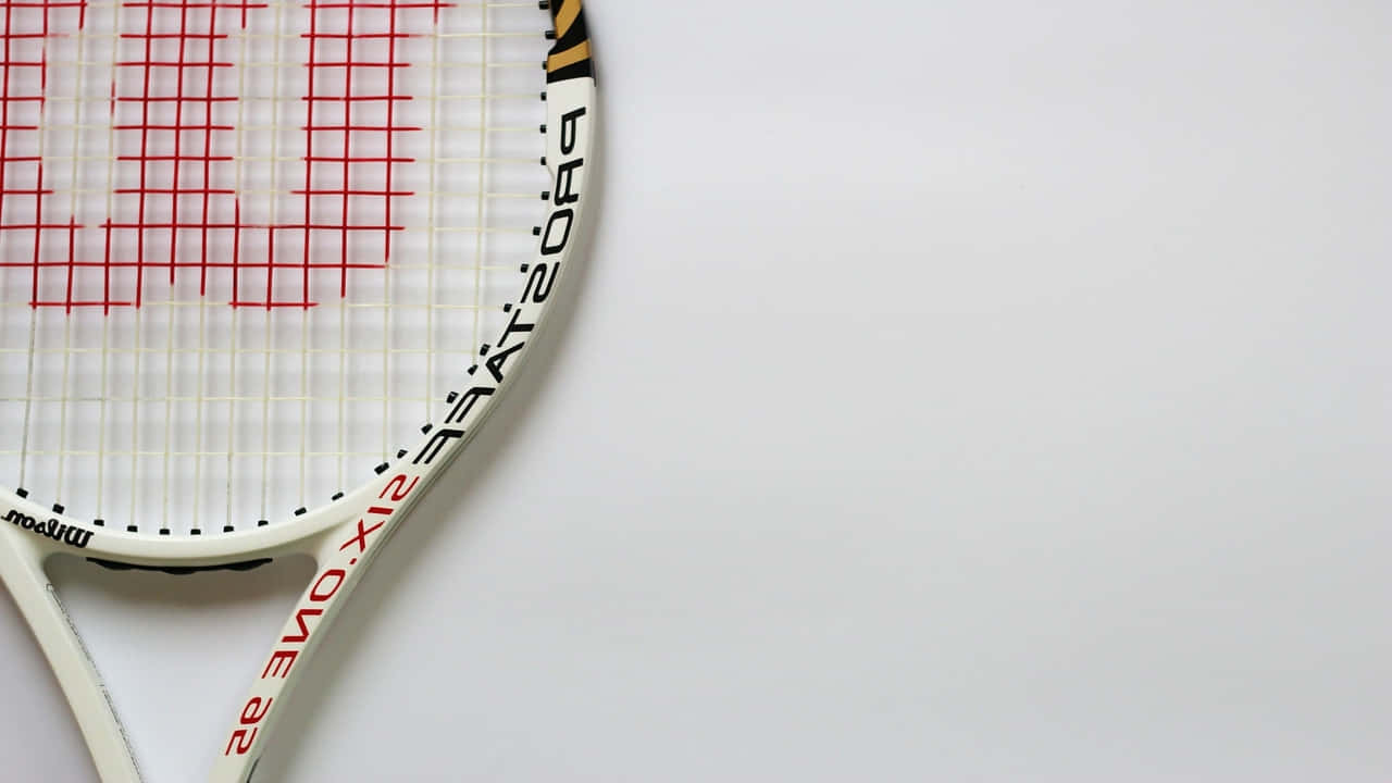 A Tennis Racket On A White Surface