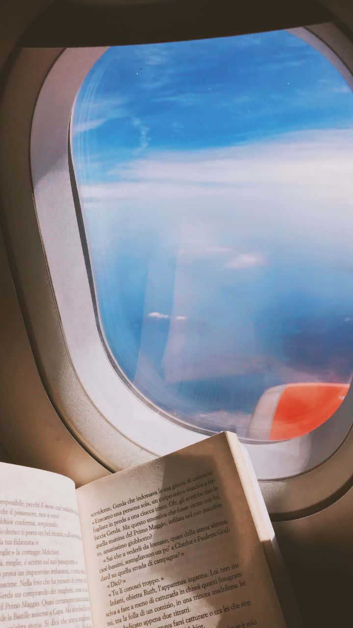 720p Travel Background Book By The Airplane Window Background