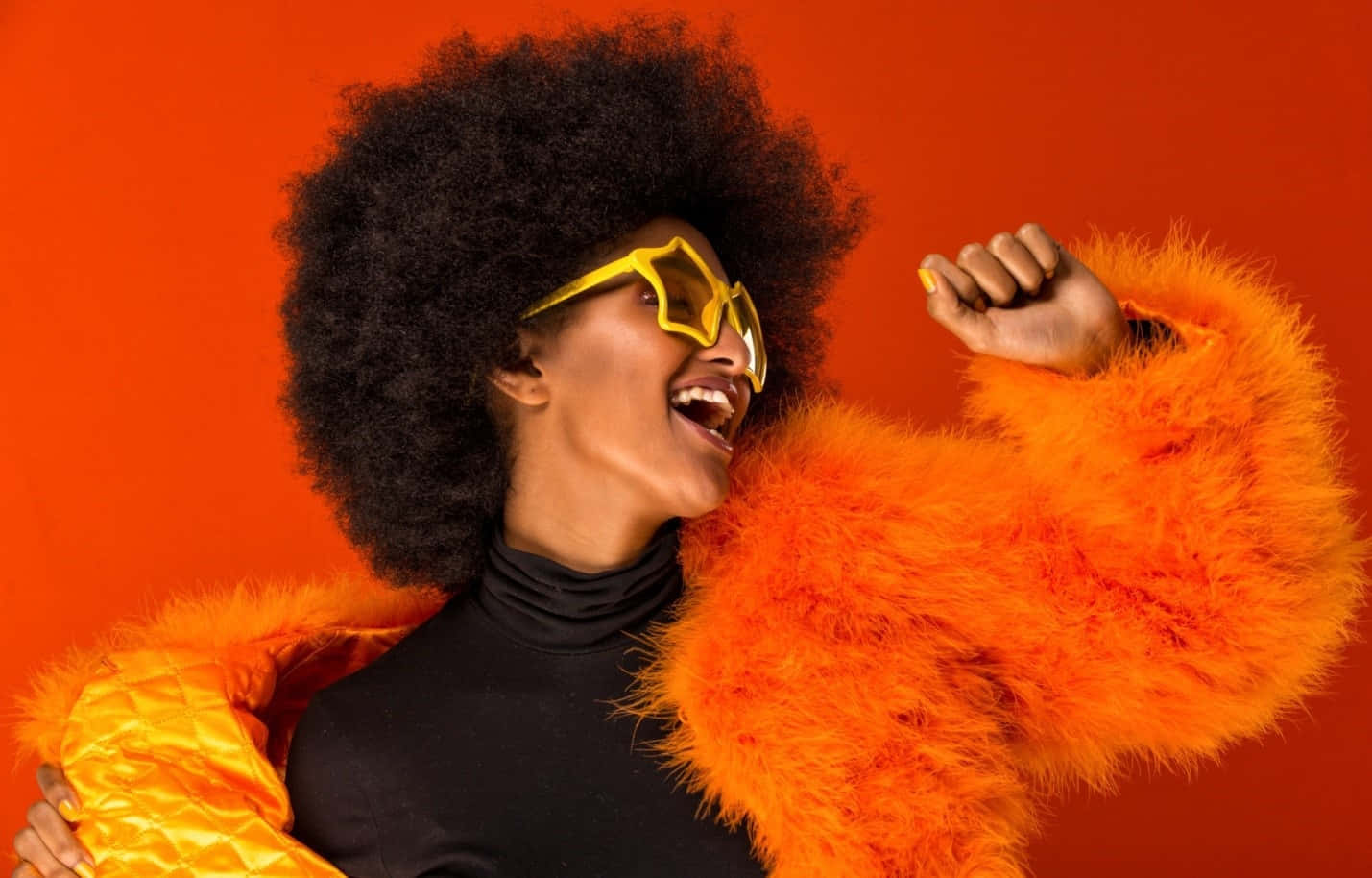 Afro Haired Woman In Orange Fur Coat And Sunglasses