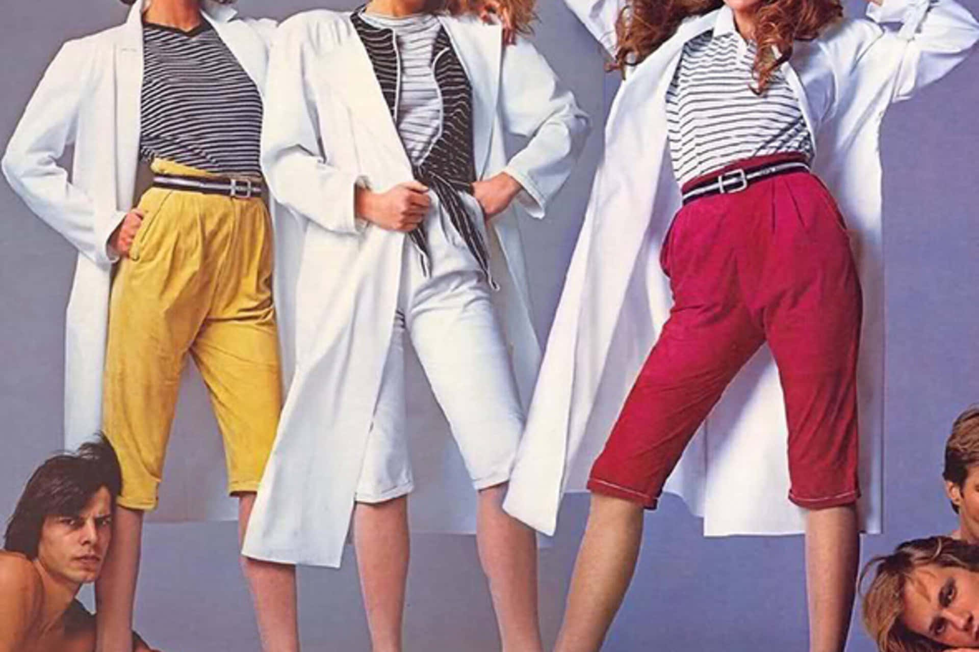 Three Women In White Coats And Shorts Posing For A Fashion Magazine
