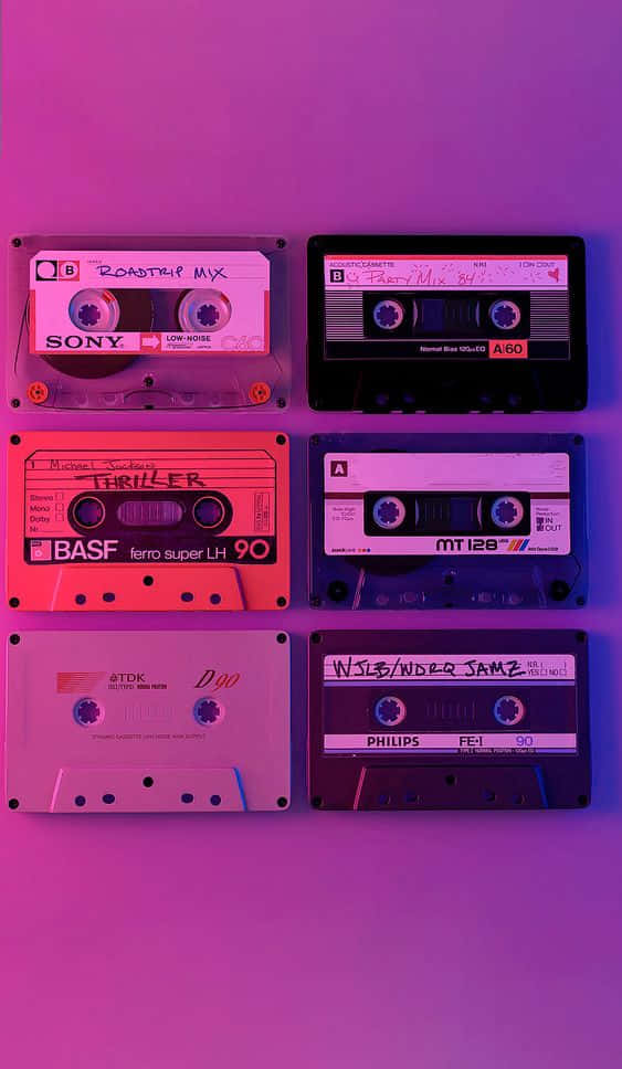 A Group Of Cassettes On A Purple Background Wallpaper