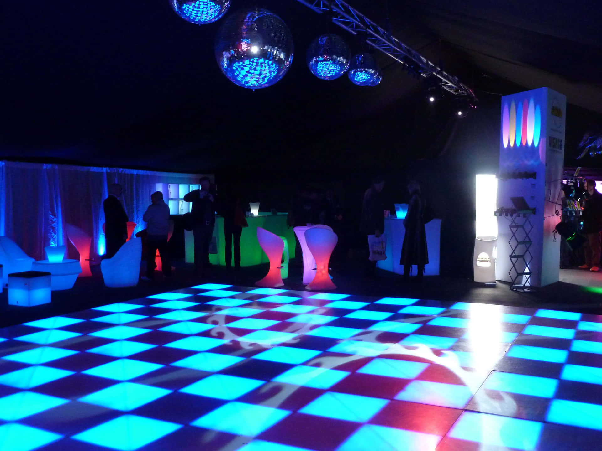 A Large Dance Floor With Blue And White Lights