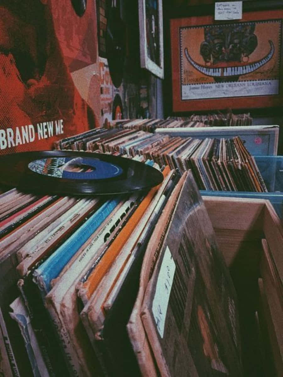 A Stack Of Records On A Shelf Wallpaper