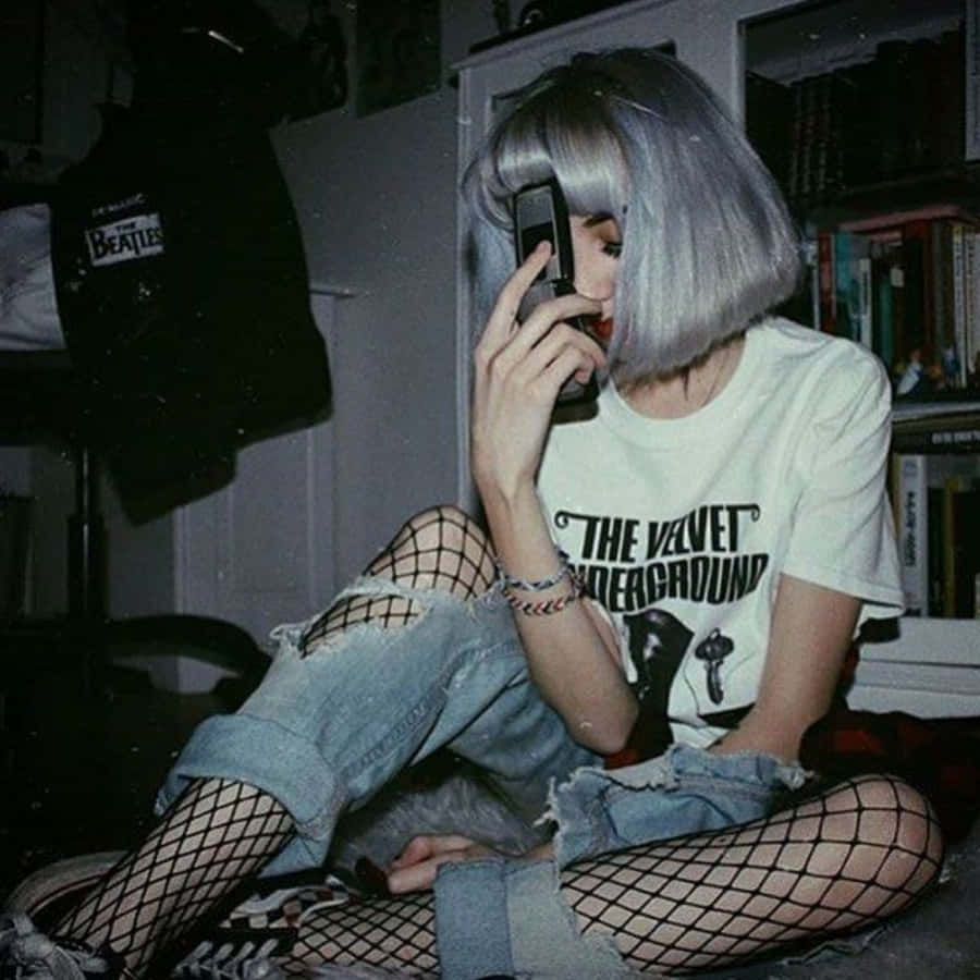 A Girl With Grey Hair And Fishnets Sitting On The Floor Wallpaper