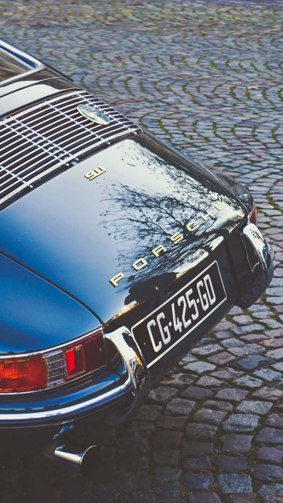 En klassisk bil parkeret på en brostensbelagt gade - Porsche 911 Wallpaper