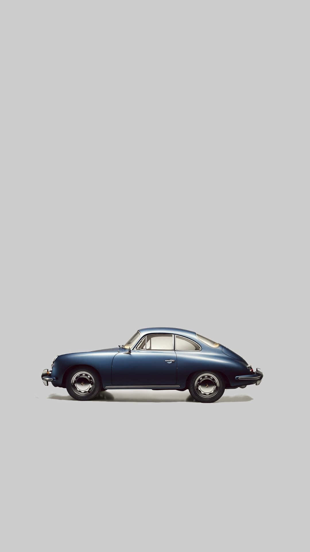 A Blue Car Is Shown Against A Gray Background Wallpaper