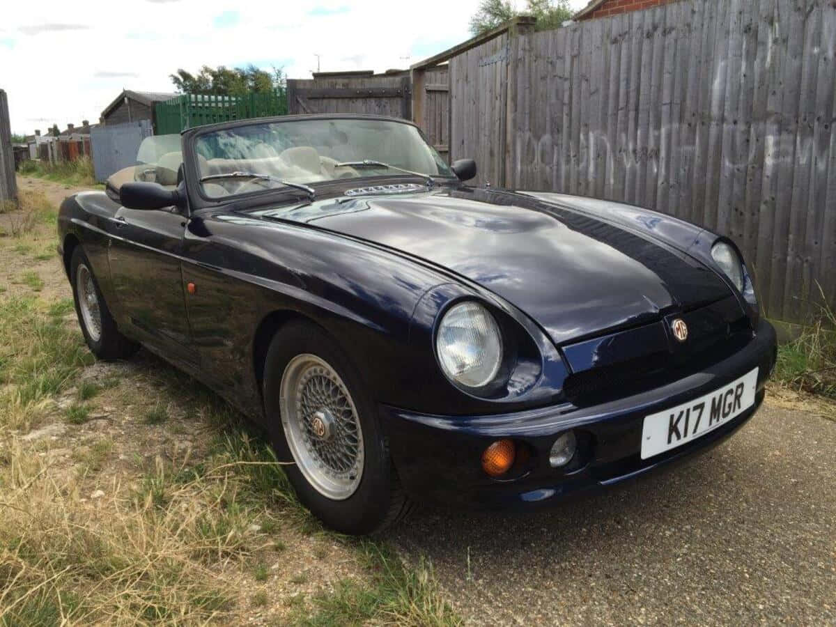 A Classic Elegance - Mg Rv8 Convertible On The Road Wallpaper