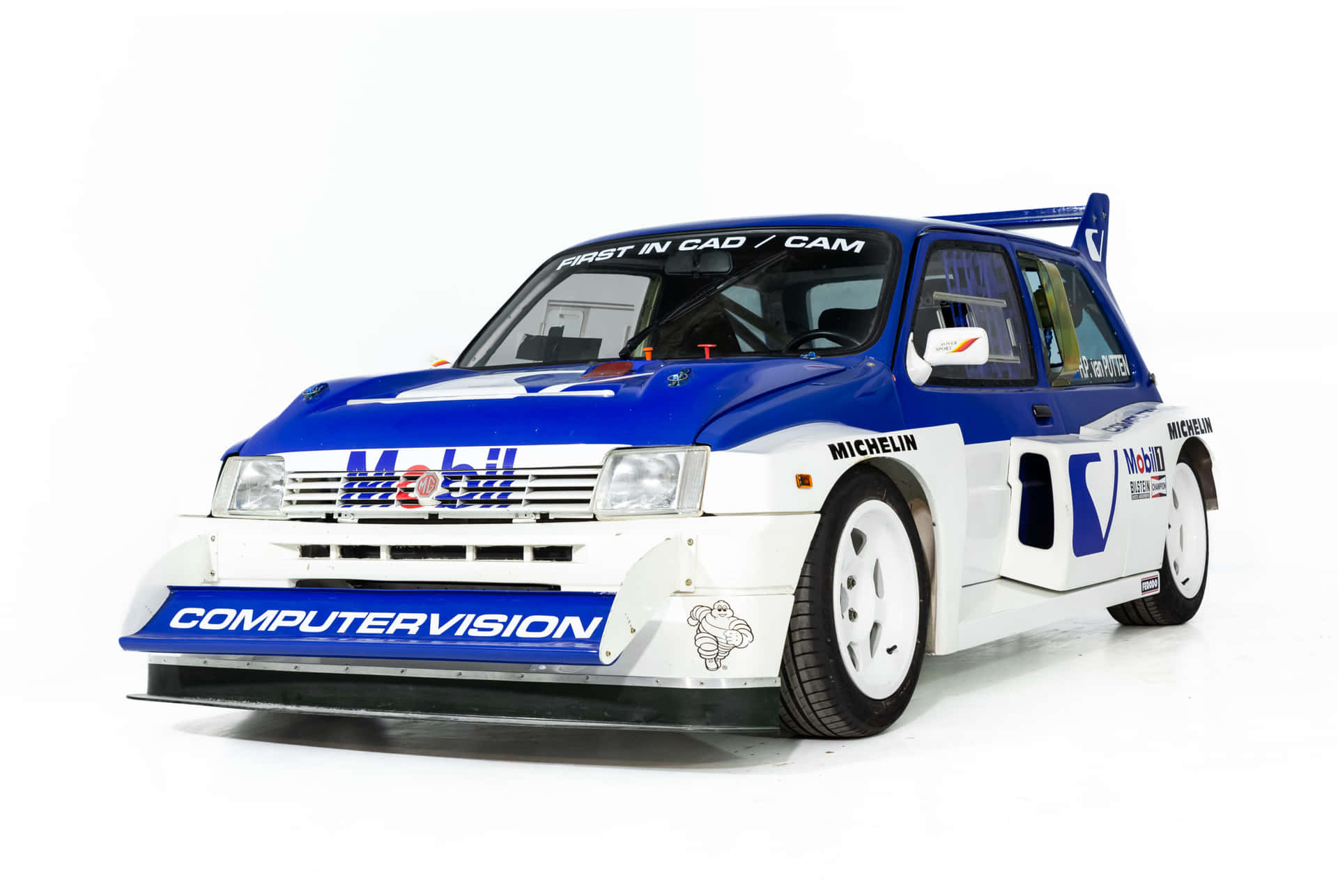 A Classic Mg Metro 6r4 In Intense Racing Action Wallpaper