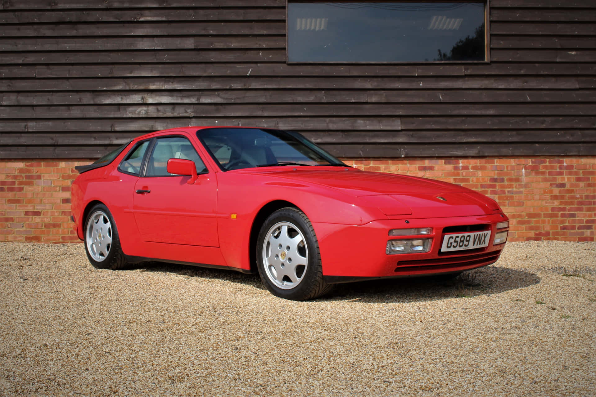 A Classic Porsche 944 Looking Radiant And Regal In Red Wallpaper