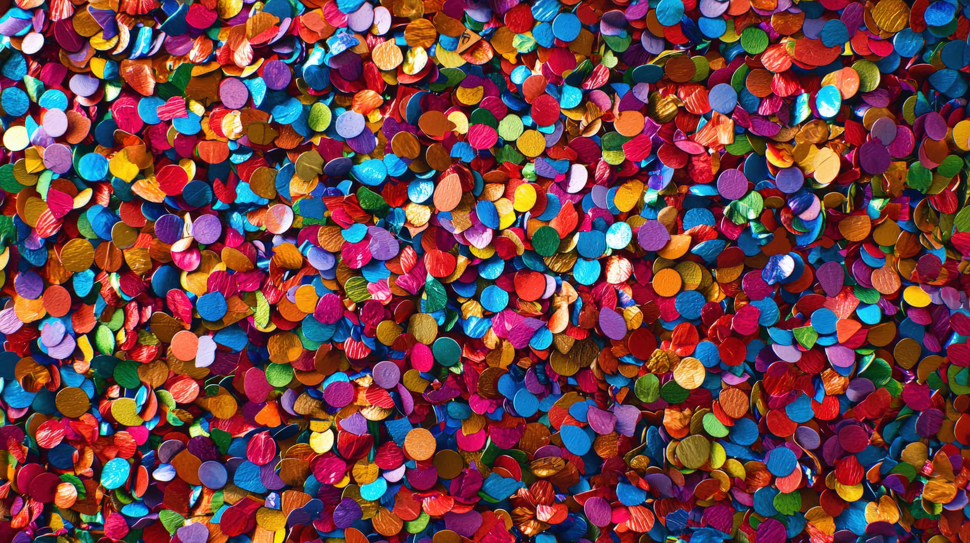 A Close-up Of Multicolored Confetti Scattered Across A Surface, Symbolizing Joy, And Celebration Wallpaper