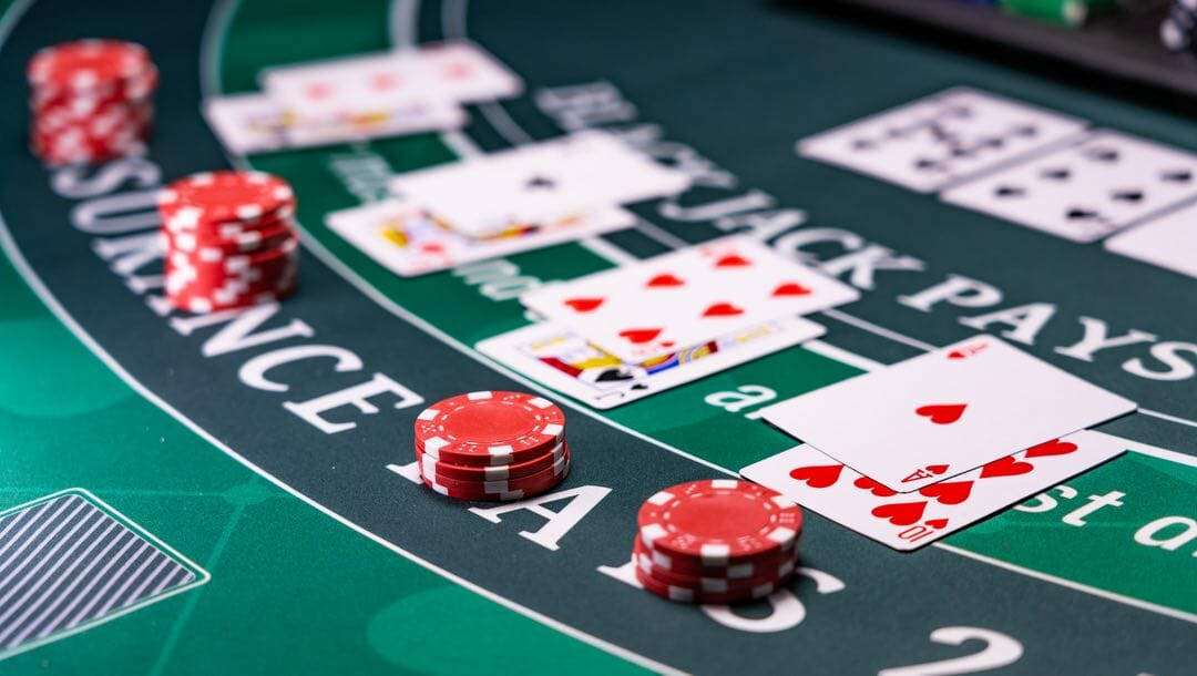 A Close-up View Of A Blackjack Game With Cards And Chips. Wallpaper