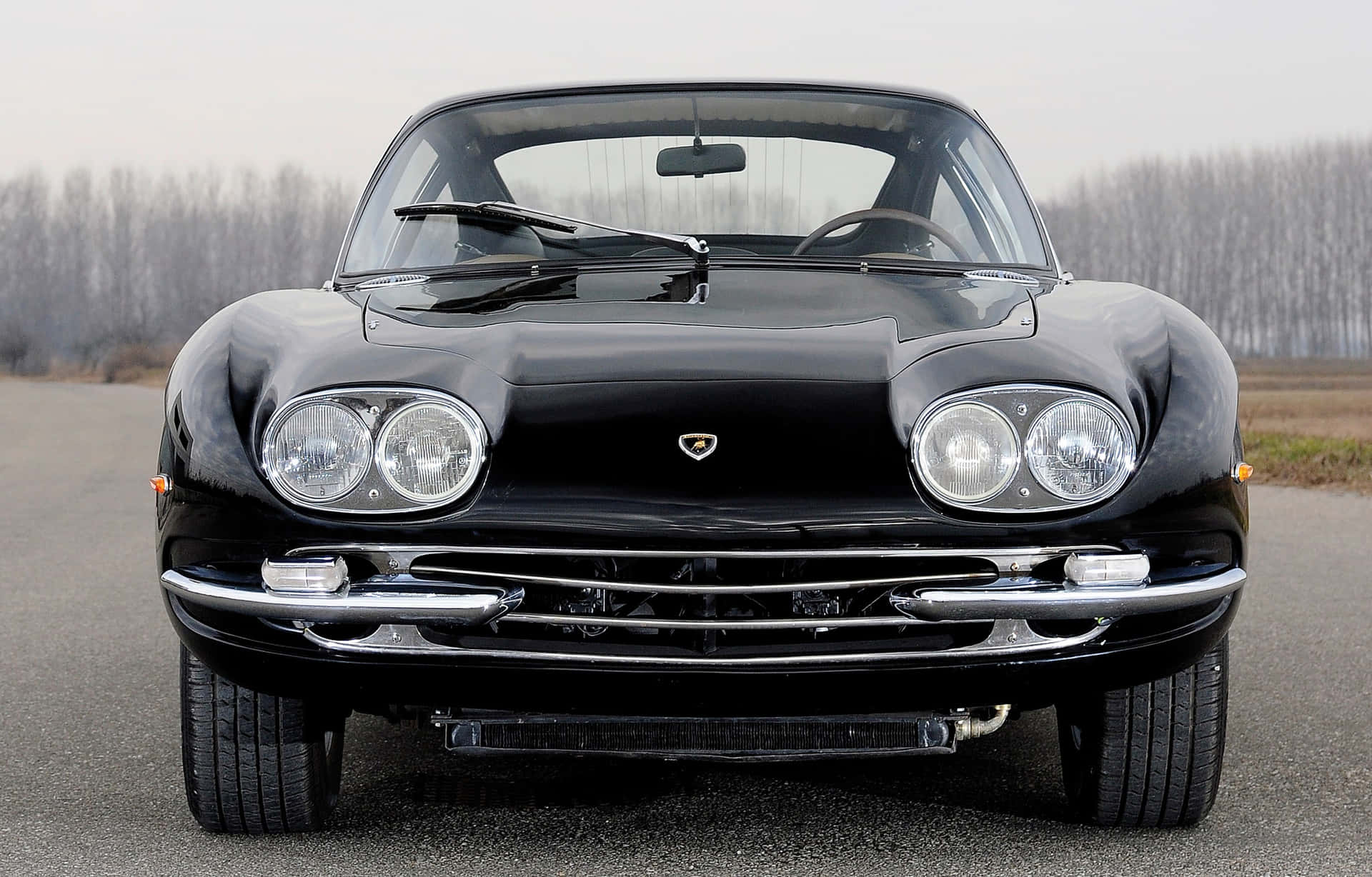A Glorious View Of The Lamborghini 400 Gt Against A Fiery Skyline Wallpaper