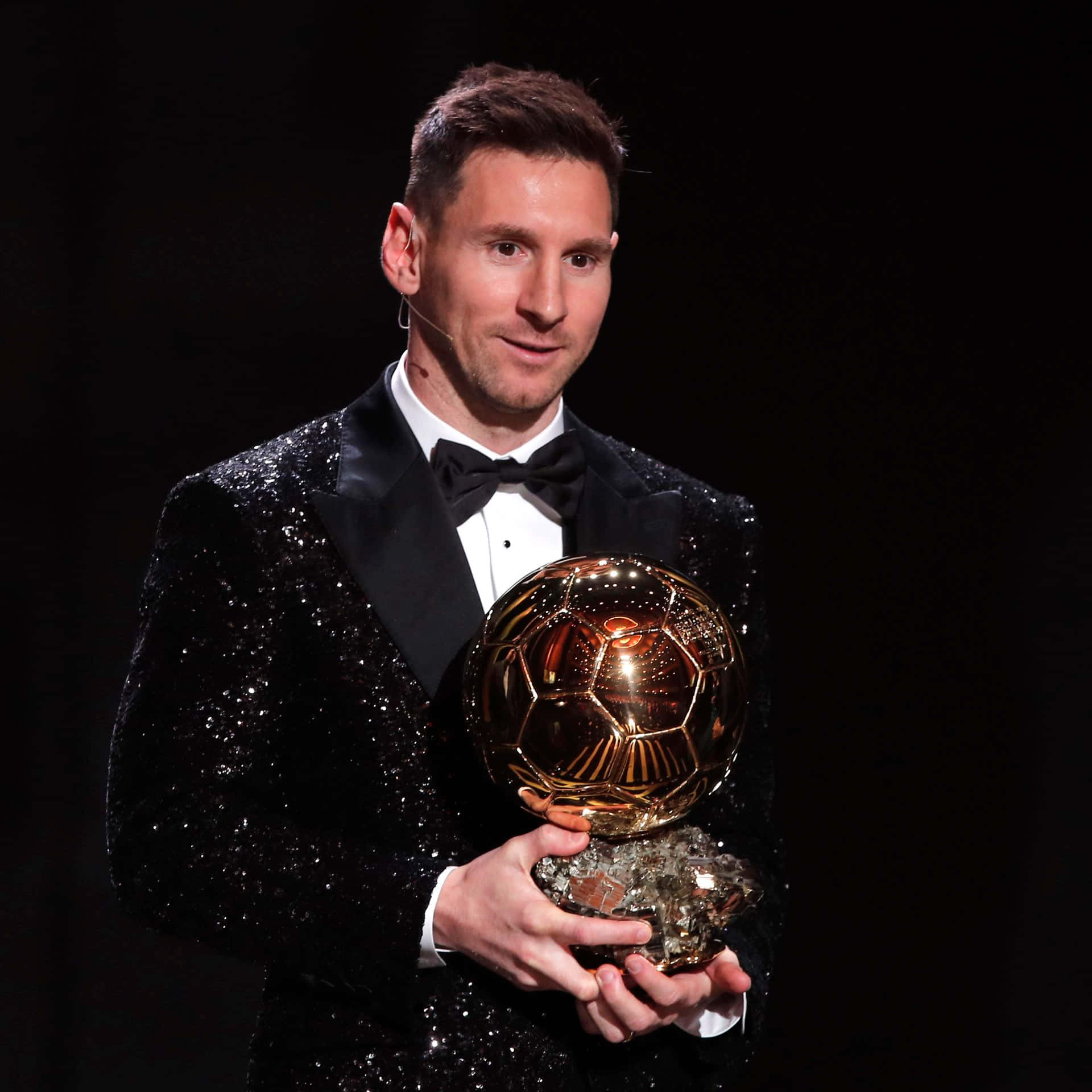 A Legendary Moment: Lionel Messi Raising His Ballon D'or Award To The Sky Wallpaper