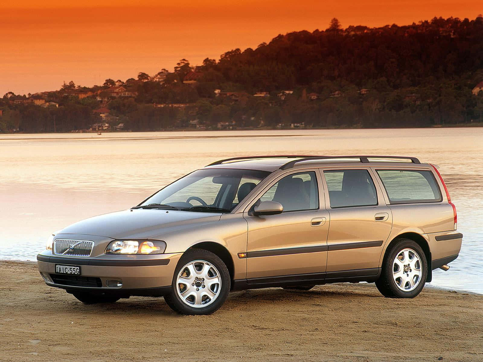 A Luxury Volvo V70 Displays Its Elegance On A Smooth Road. Wallpaper