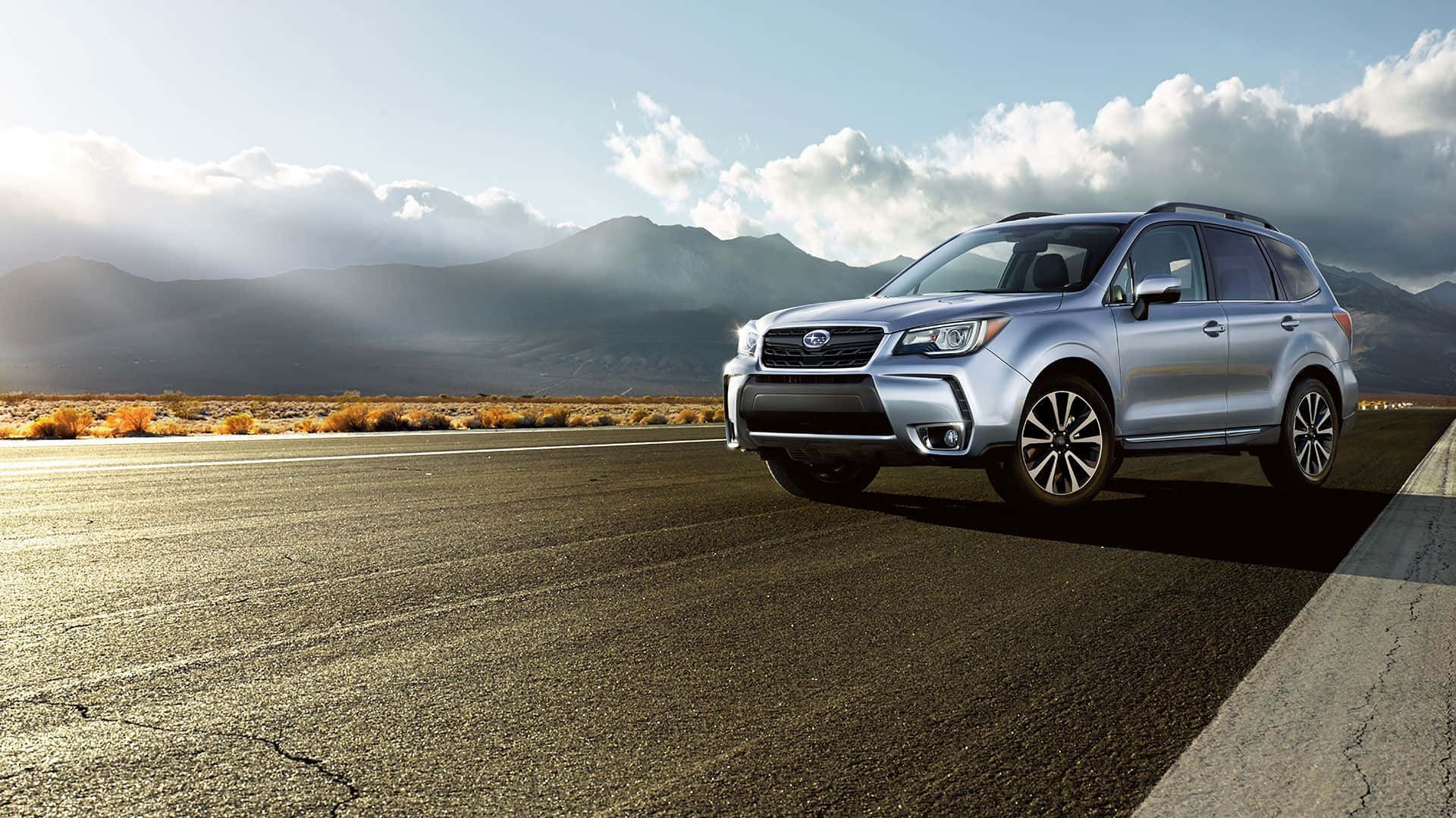 A Majestic Subaru Forester Set Against A Stunning Sunset Wallpaper