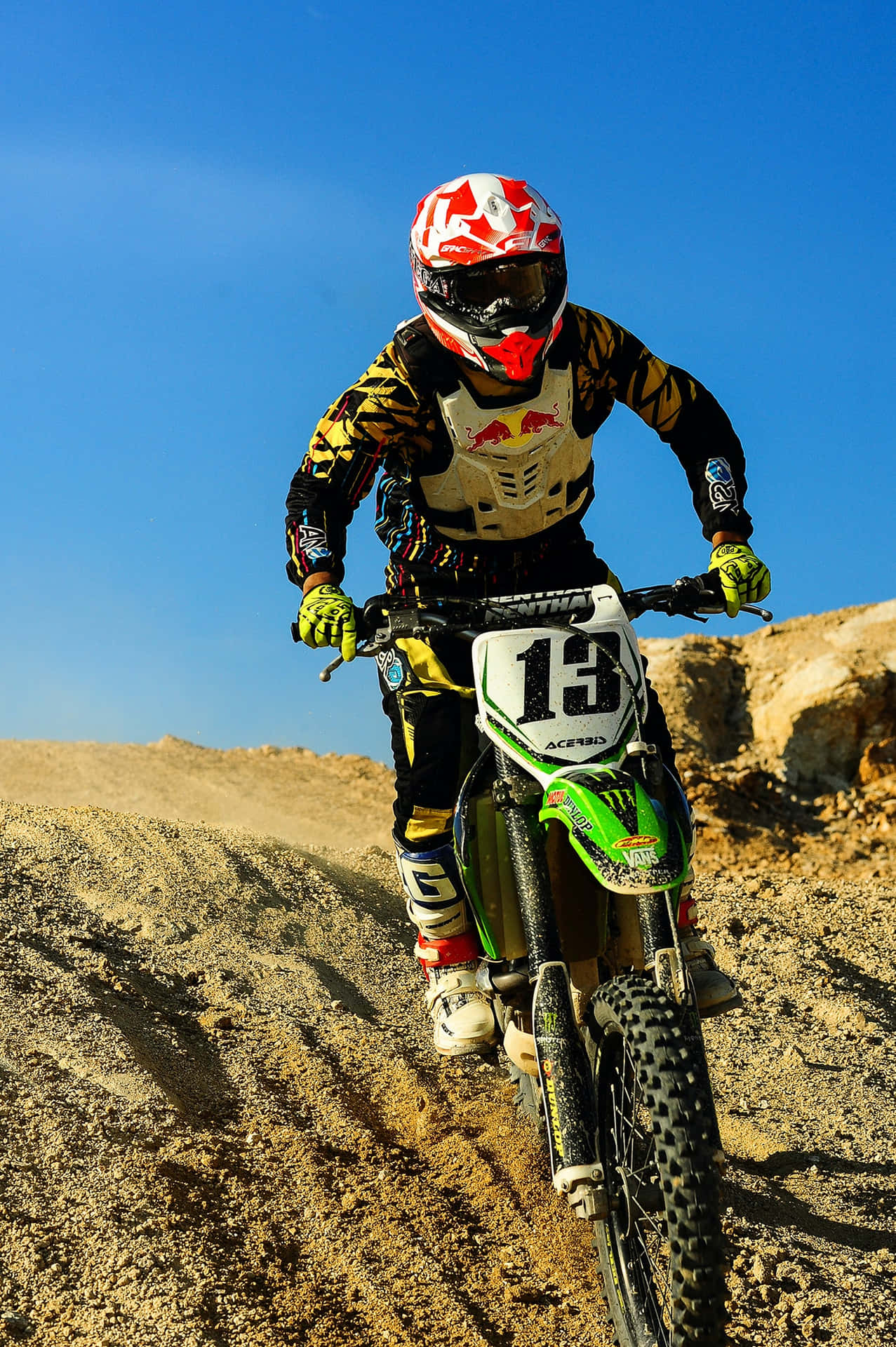 A Motocross Racer Jumps High Against A Clear Sky