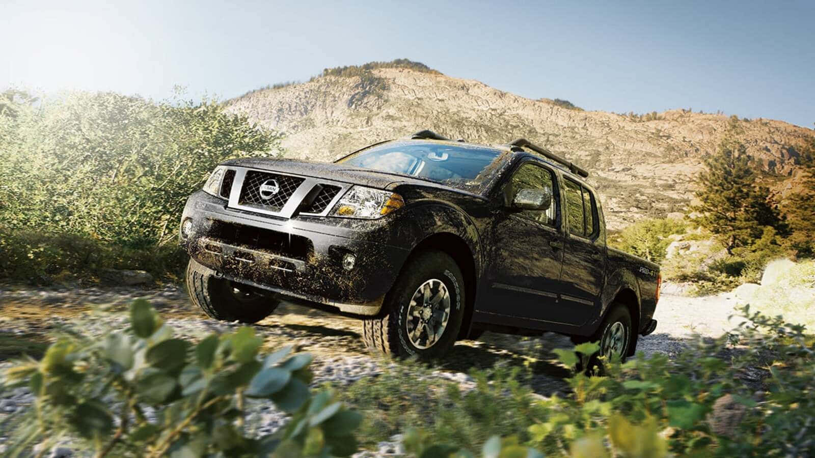 A Nissan Frontier Showcasing Its Robustness In An Off-road Journey. Wallpaper