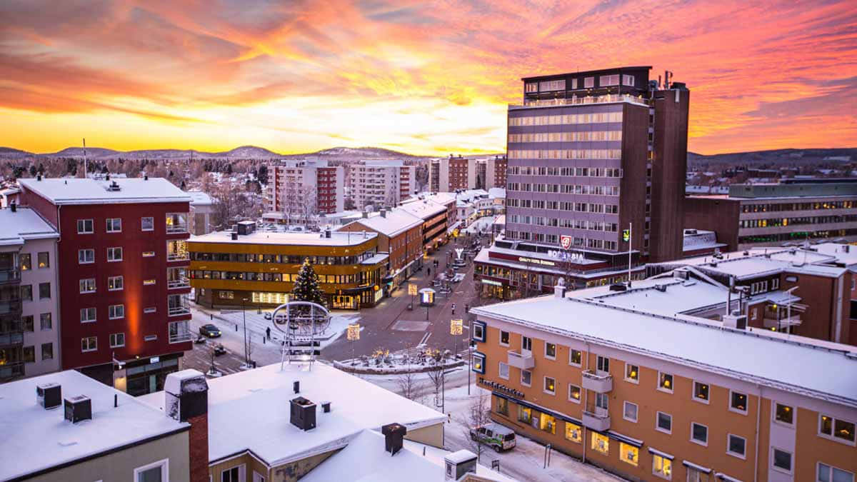 A Picturesque Northern Lights Display Over Luleå City Wallpaper