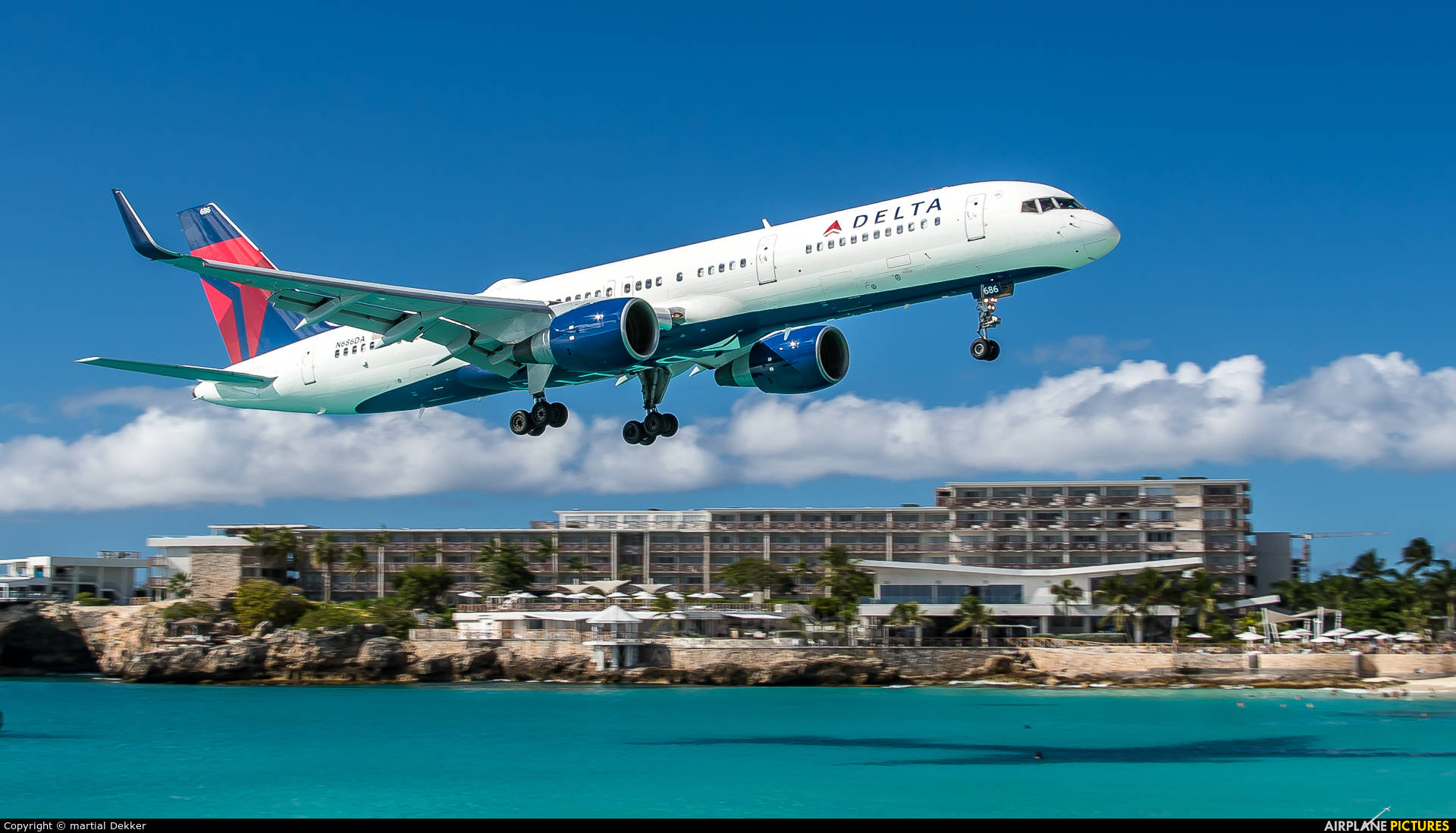 A Plane Landing At Sint Maarten Airport Wallpaper