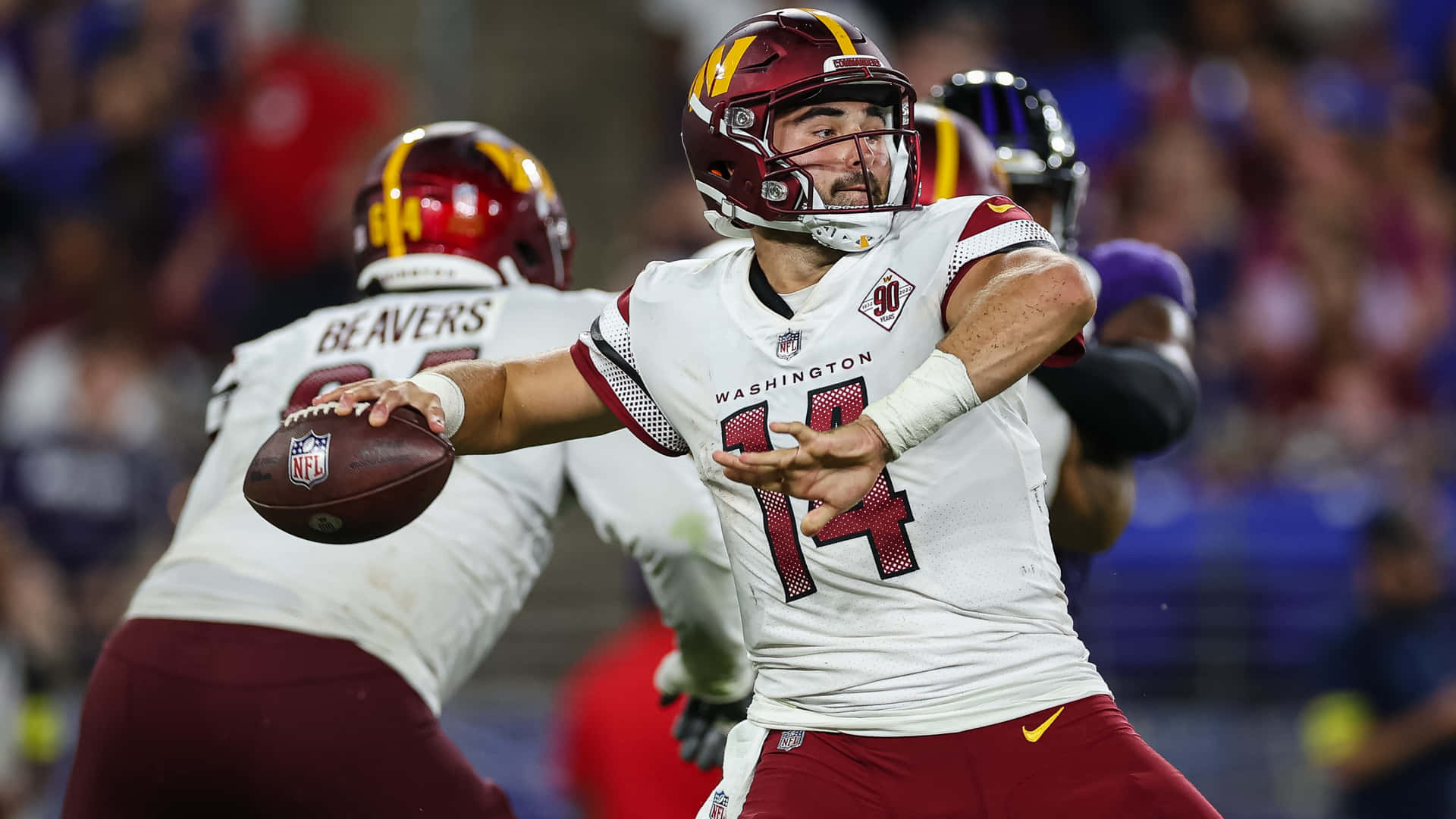 A Poised Nfl Quarterback Ready To Unleash A Powerful Throw Wallpaper