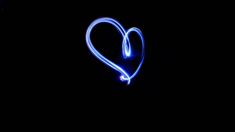A Radiant Blue Heart Glowing In The Mystical Fog. Wallpaper