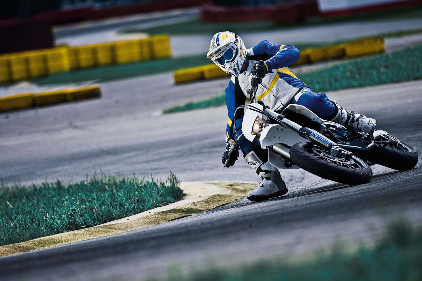 A Rider On A Husaberg Enduro Motorcycle On Rough Terrain Wallpaper