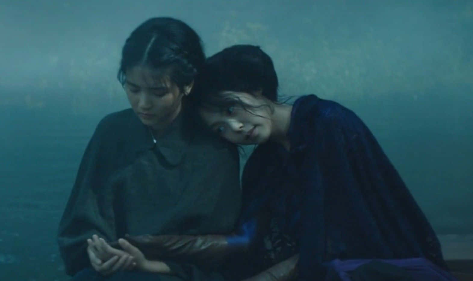 A Scene From The Handmaiden Film Featuring The Lead Actresses In A Serene Garden Wallpaper