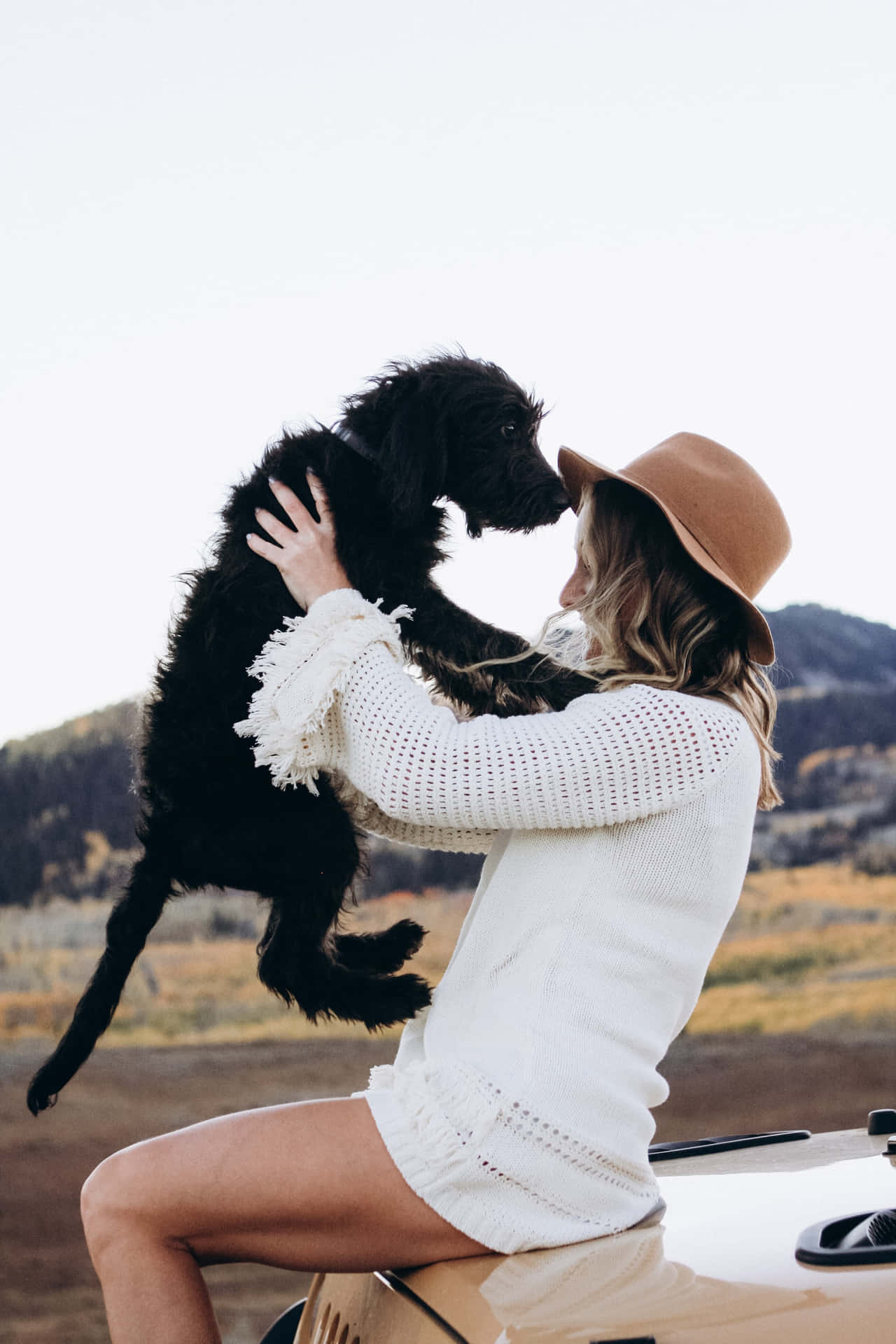 A Serene Moment Of Companionship Between A Woman And Her Dog Wallpaper