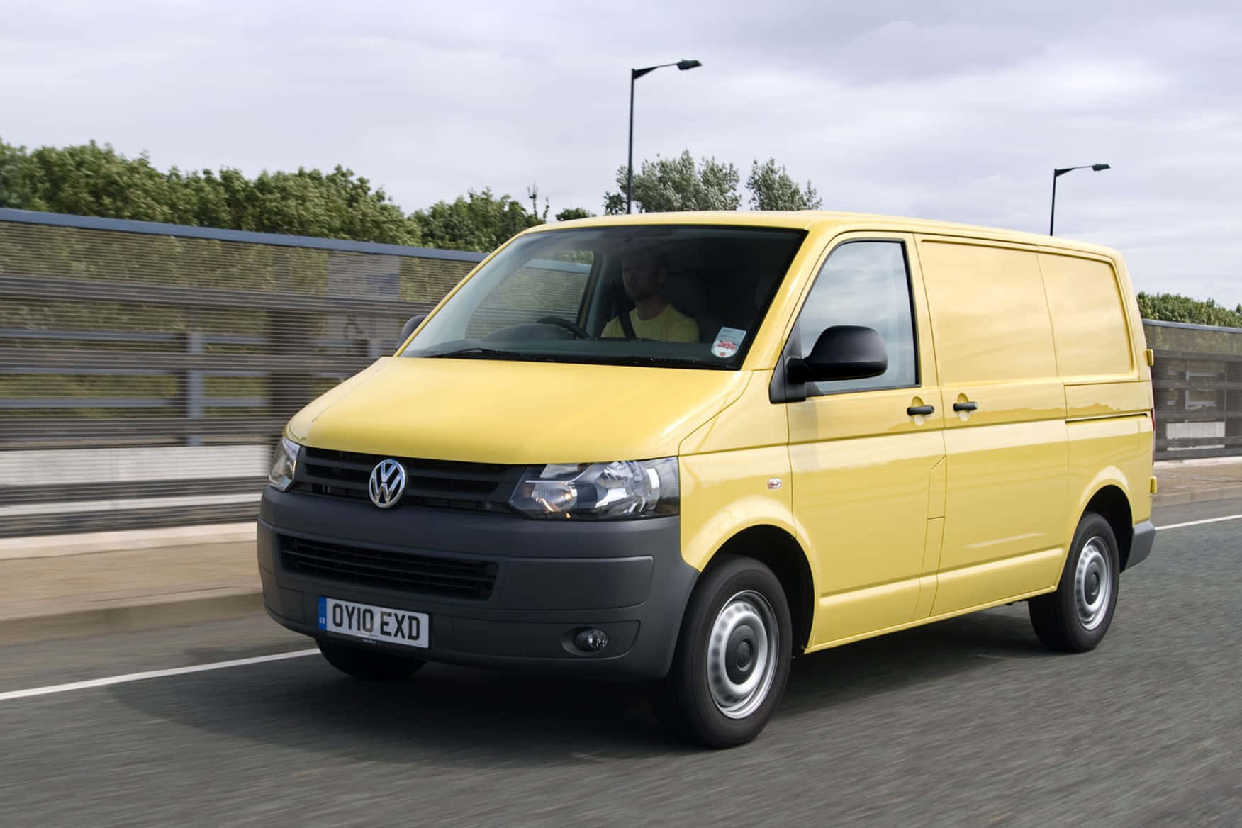 A Shiny New Volkswagen Transporter Parked On A Road Wallpaper