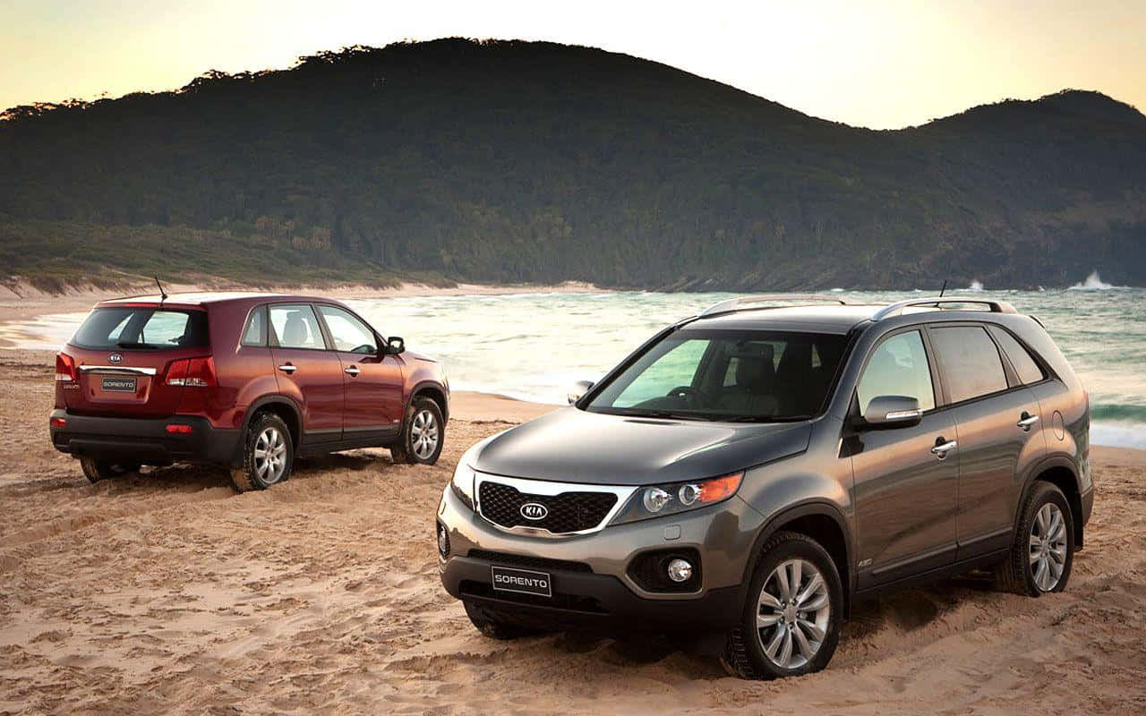 A Silver 2021 Kia Sorento Parked At The Edge Of The Serene Lake Wallpaper