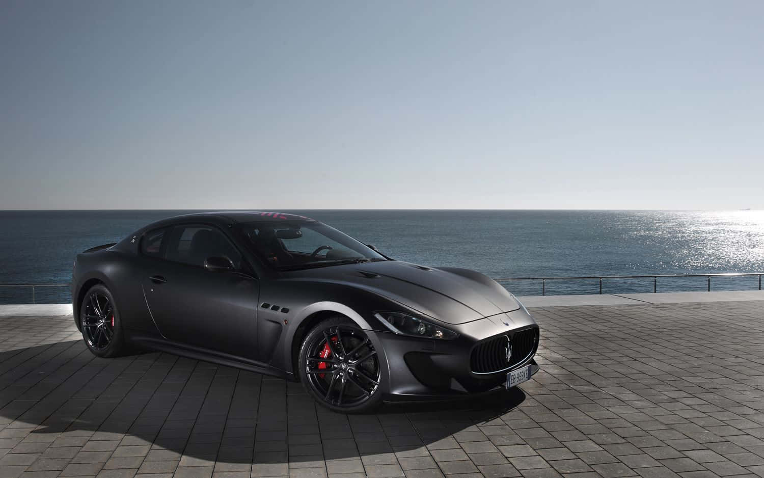 A Sleek And Luxurious Maserati Granturismo Against A Scenic Backdrop Wallpaper