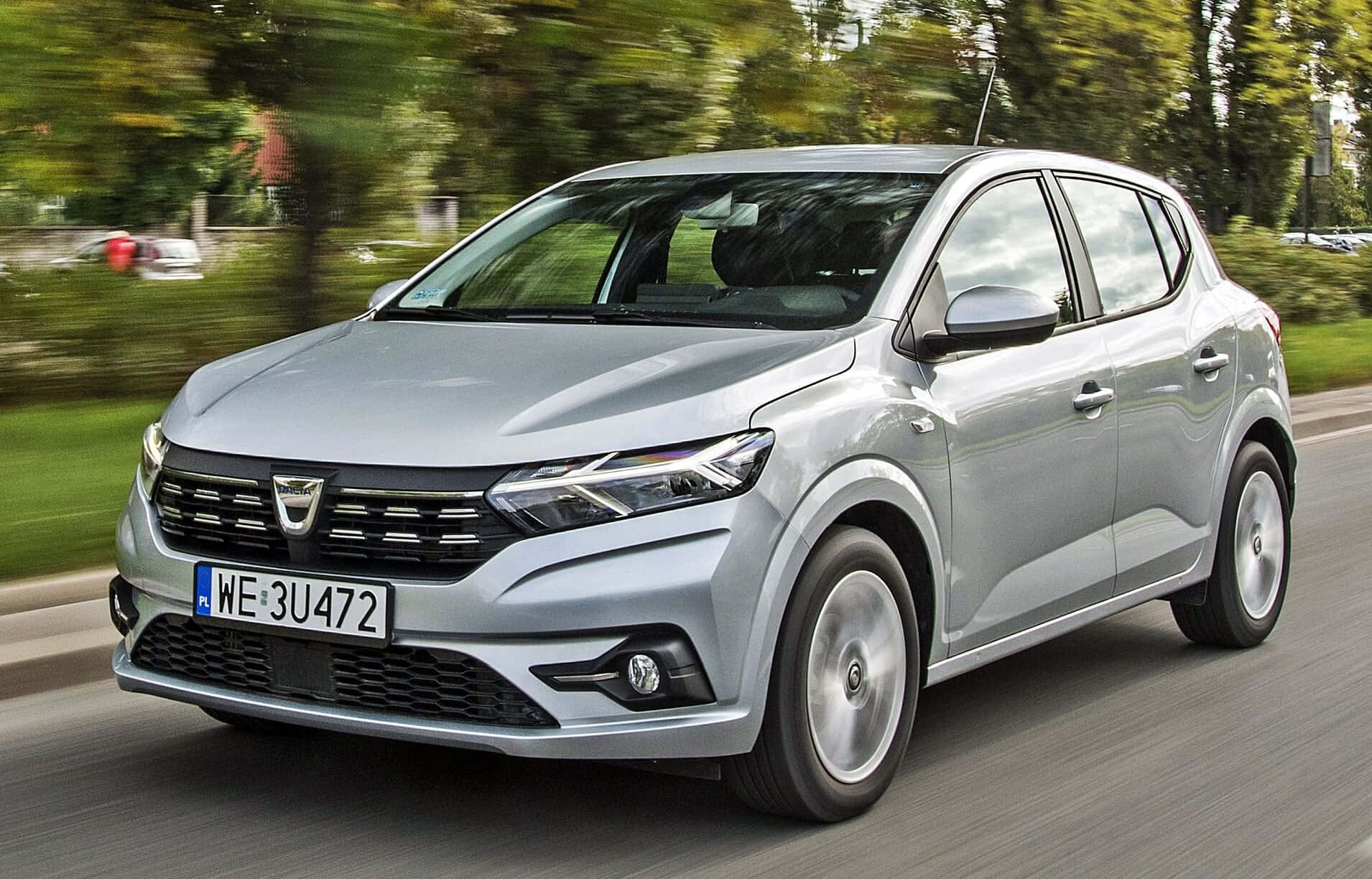 A Sleek Dacia Sandero Gliding Across A Serene Landscape Wallpaper