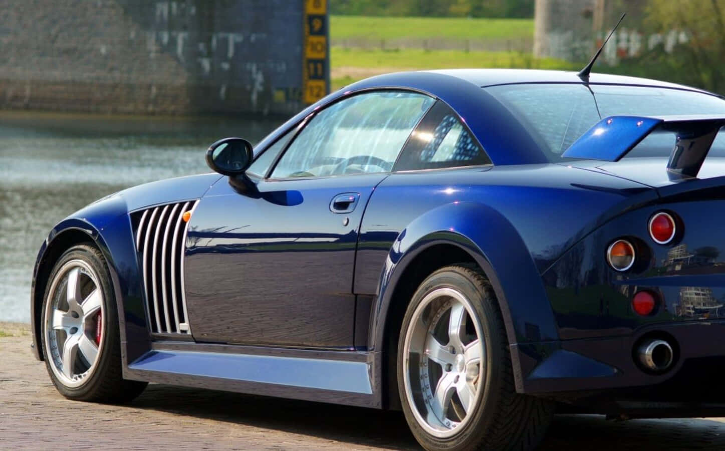 A Sleek, Luxurious Mg Xpower Sv Sports Car In A Scenic Outdoor Setting. Wallpaper