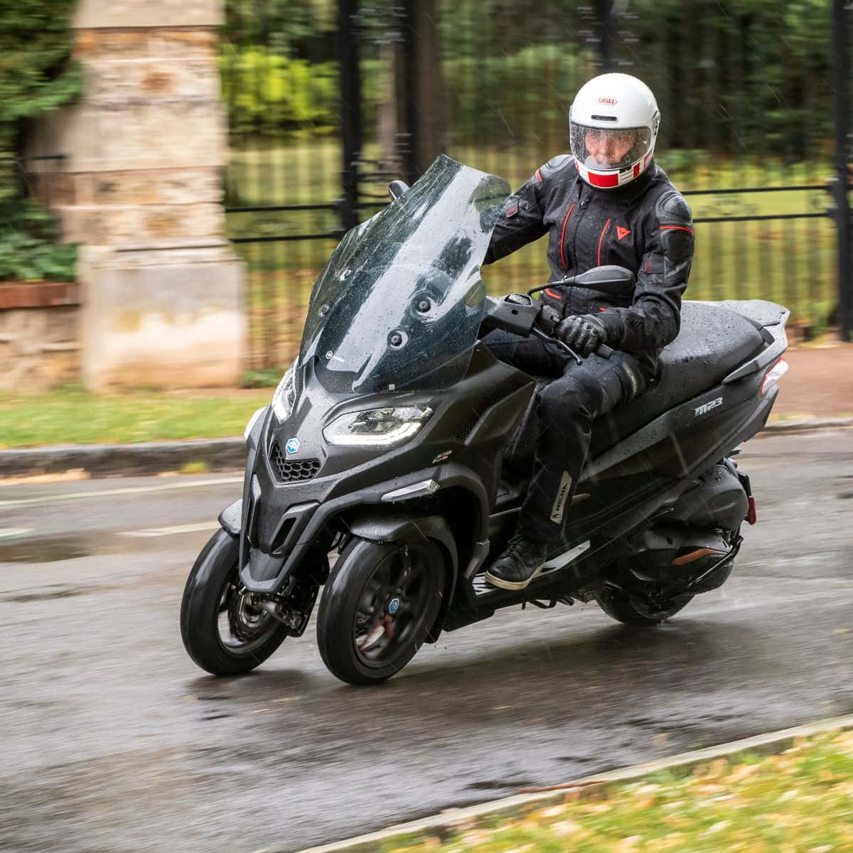 A Sleek Piaggio Scooter Cruising Through The City Streets. Wallpaper