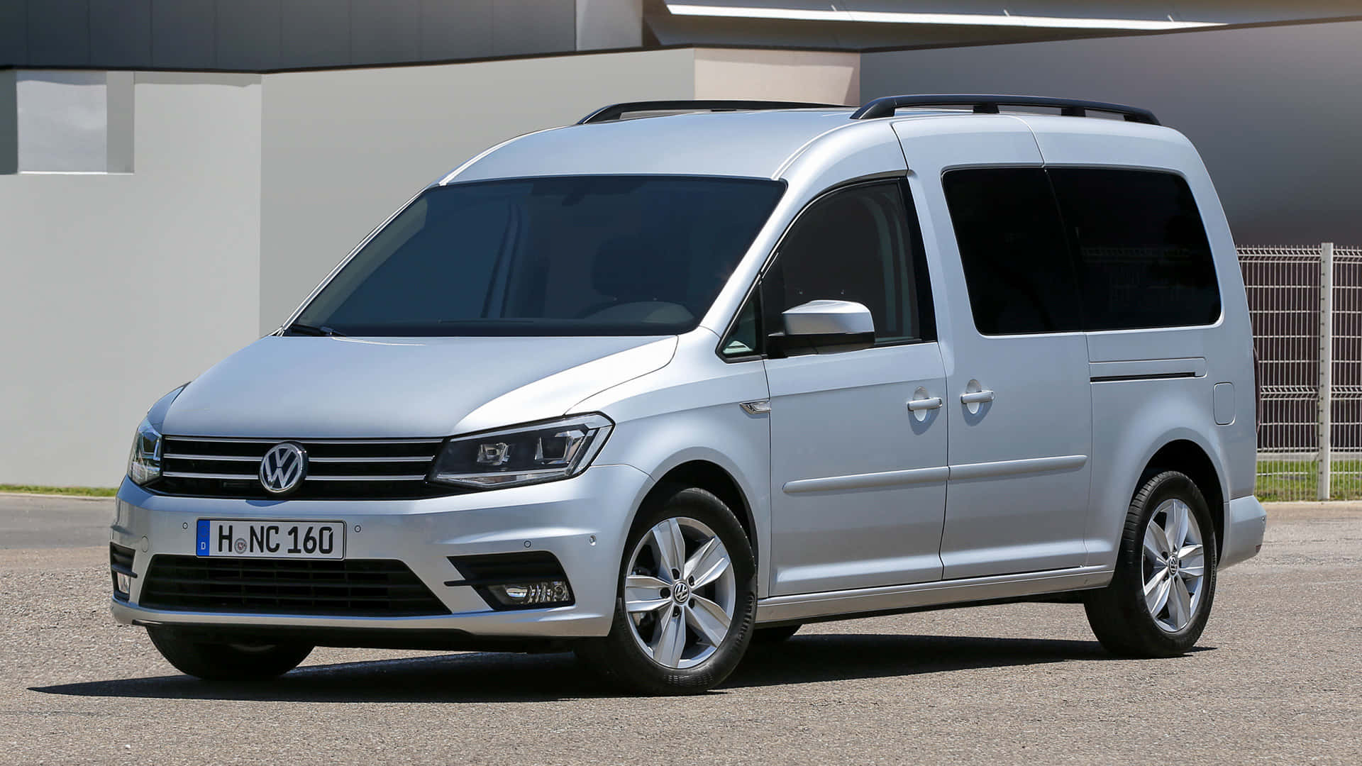 A Sleek Volkswagen Caddy Showcasing Its Dynamic Design On The Road. Wallpaper