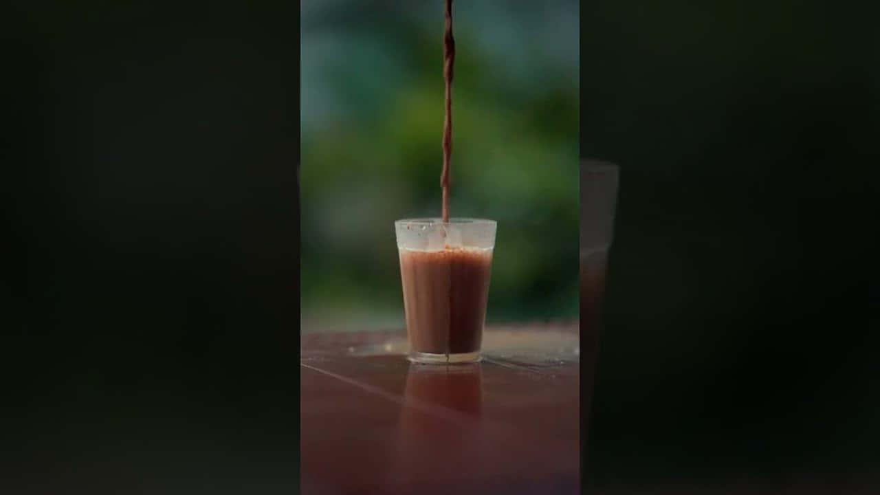 A Steaming Cup Of Traditional Chai In A Serene Setting Wallpaper