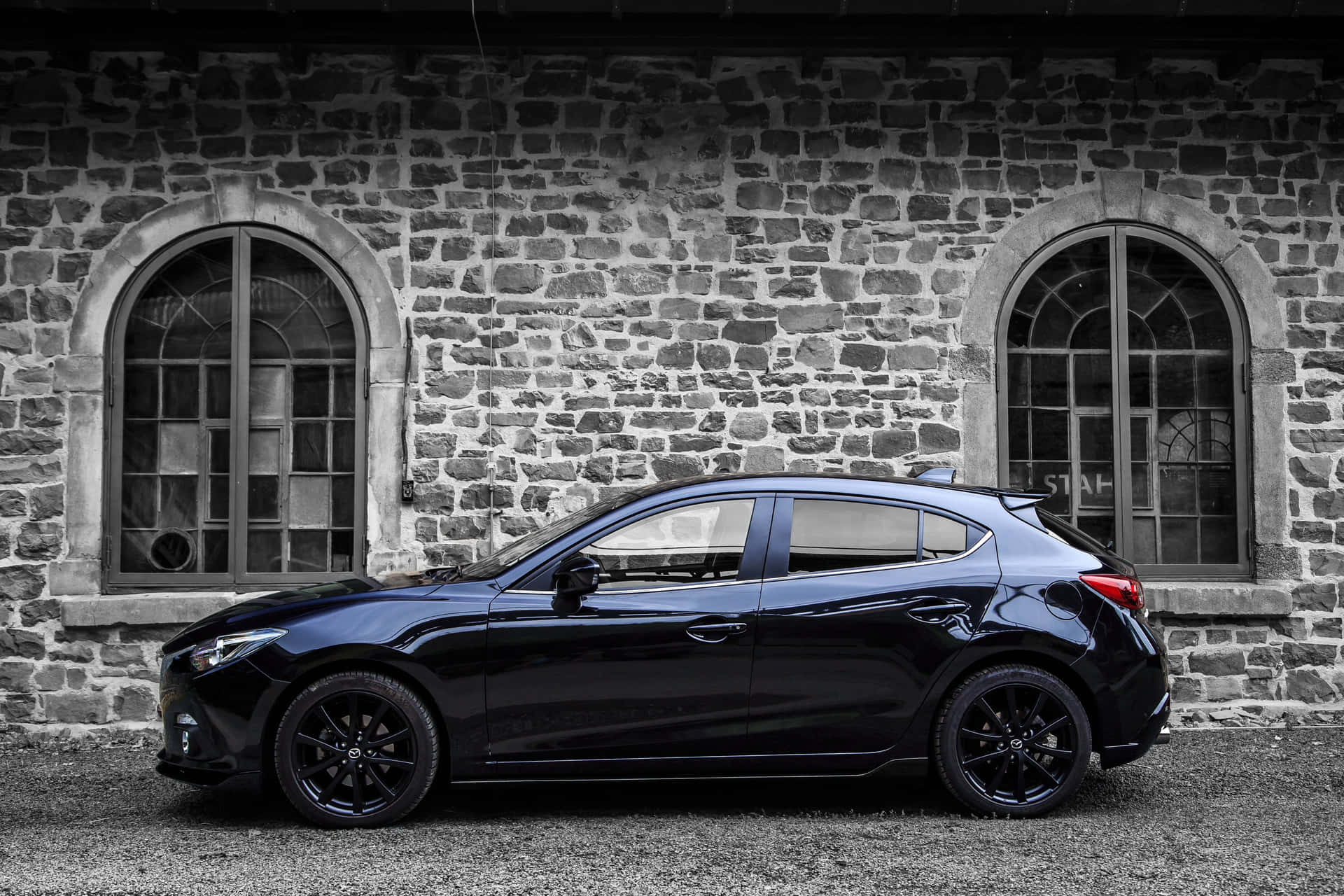 A Stylish Mazda 3 Hatchback In Spectacular Movement Wallpaper
