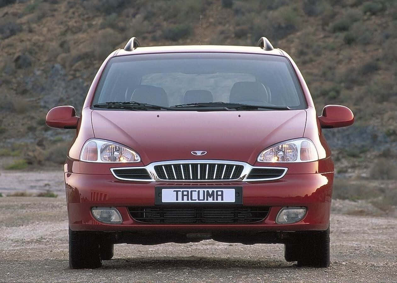 A Stylish Silver Daewoo Tacuma On An Open Road Wallpaper